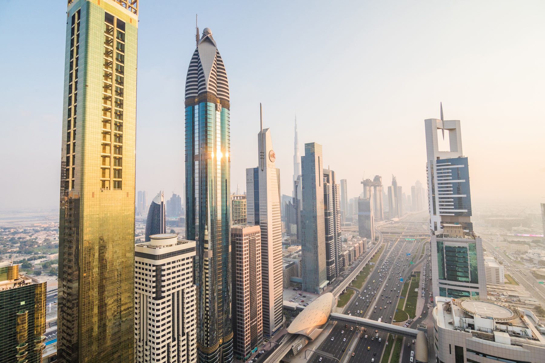 A Gulf city skyline of modern towers along the waterfront