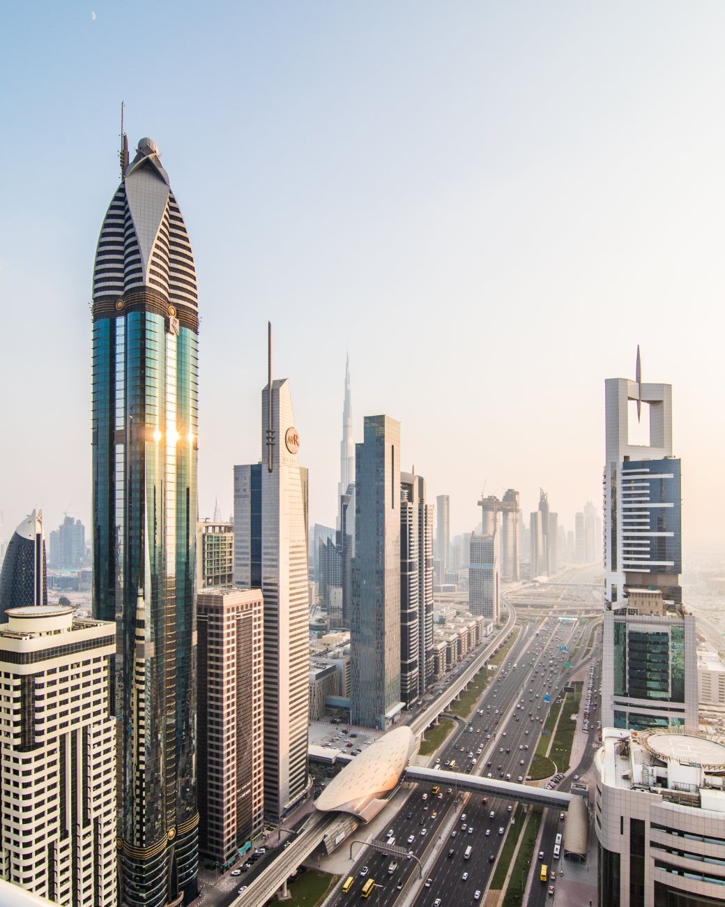 Downtown Dubai at sunset, the Burj Khalifa rising beyond Sheikh Zayed Road